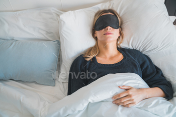  sleeping with sleep mask at hotel room. Travel concept.