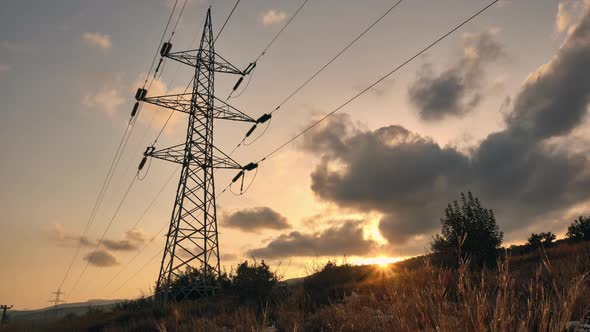 Power Line Pylon Against Evening Cloudy Sky