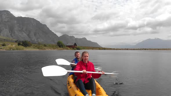 Animation of Caucasian people grumbling in a yellow canoe, montains and white clouds