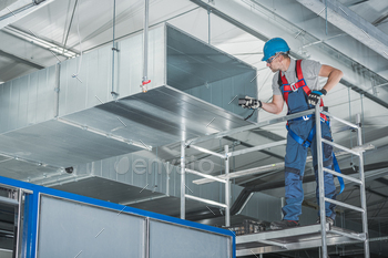 HVAC Technician Testing Newly Installed Warehouse Ventilation System
