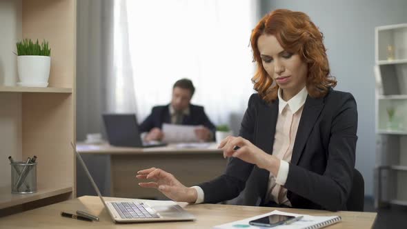 Woman Typing on Laptop, Taking Cellphone to Check Information, Company Employee