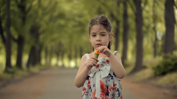 Young Children Enjoy Playing Funny Activity Together With Father. Little Girl Blowing Soap Bubbles.