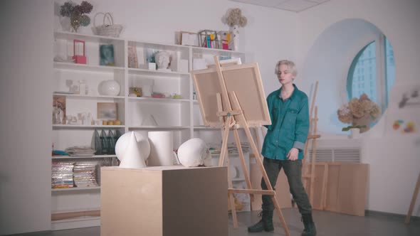 A Young Woman Artist Drawing a Skull and Other Figures From the Table