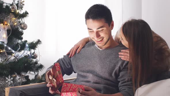 Romantic Couple Exchanging Christmas Gifts.