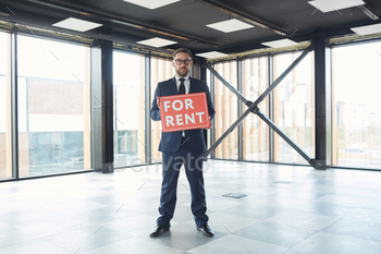 ing at camera and holding placard he suggesting office space for rent