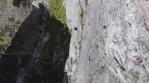 Closeup Shot of a Drone Flying Over a Cliff Revealing It's Scree