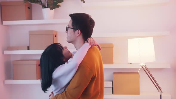 Young Asian Couple Dancing and Hugging in New Apartment