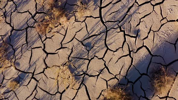 Looking down at the cracked surface of a dry river