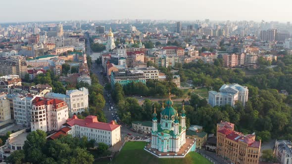 Beautiful flight over St. Andrew's Church in Kiev. Top view of Podol. Many buildings and churches.