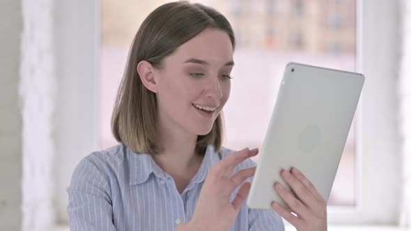 Portrait of Attractive Young Woman Working on Tablet