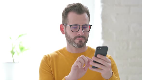 Portrait of Man Celebrating on Smartphone