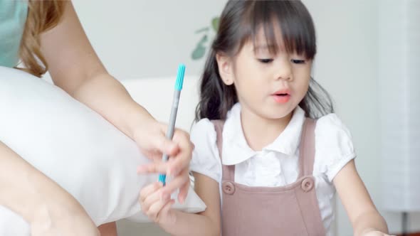 An Asian mother Teaching Her Daughter to Draw 03