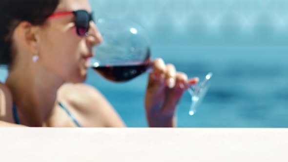 Medium Closeup Portrait Relaxing Woman in Sunglasses Sunbathing Enjoying at Pond Drinking Red Wine