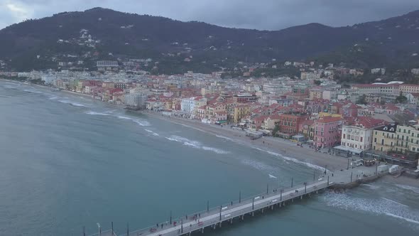 Aerial view of Alassio city and pier by the sea in Liguria, Italy