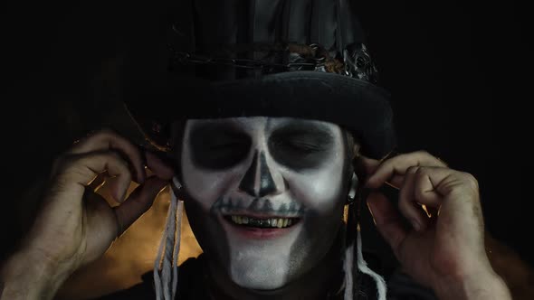 Sinister Man with Horrible Halloween Skeleton Makeup Puts on Headphones, Starts Dancing, Celebrating