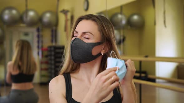 Beautiful Woman Fitness Instructor Coach Take Off Two Medical Protective Masks and Can Feel Relief