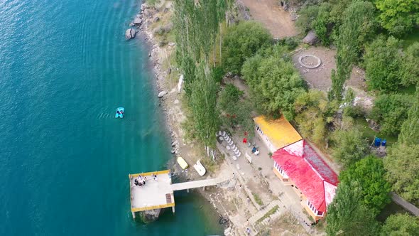 aerial drone circling a pier at Upper Kachura Lake in Skardu Pakistan during a sunny summer afternoo