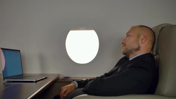 Rich Entrepreneur Work on Notebook Inside of Private Jet