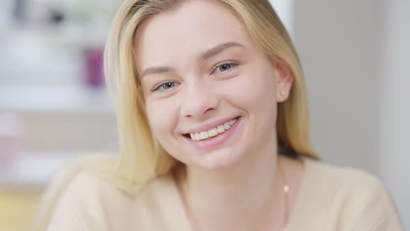 Headshot of Cheerful Happy Beautiful Young Woman Laughing Looking at Camera