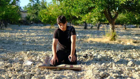 Young Man Praying Outdoors