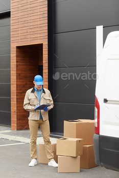 he accepting parcels while standing outdoors near the warehouse