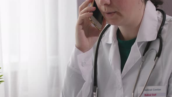 Female Woman Doctor in Medical Coat Stethoscope Talking on Phone in Office Room