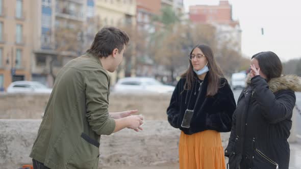 Side View of Magician Showing Magic Tricks to Unknown Person in the Street