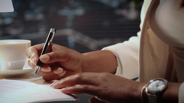 Close Up of African American Woman's Hands Signing Agreement