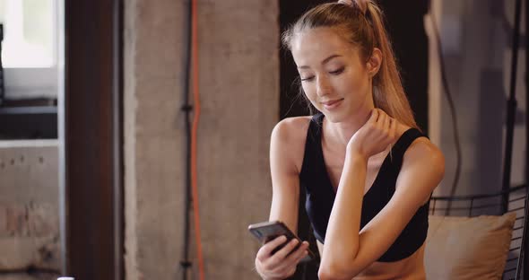 Confident Athlete Using Mobile Phone At Gym