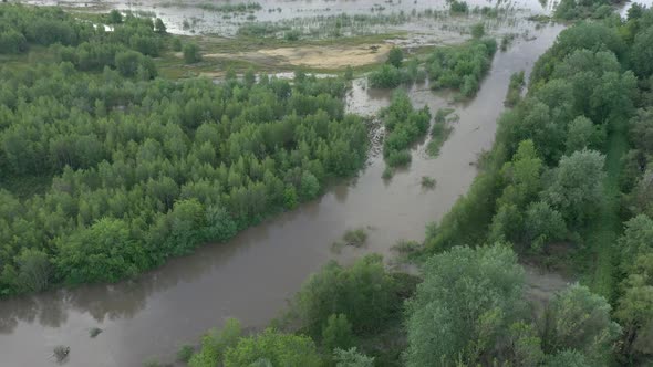 Overflown banks of river after long periods of raining 4K drone video