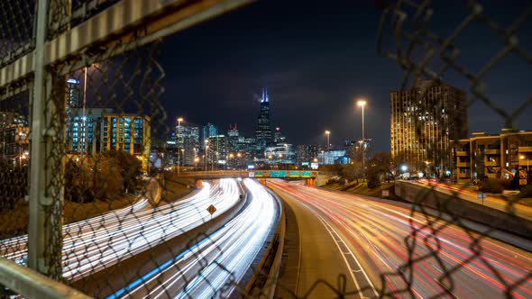 Five second long exposure time lapse push in revealing traffic through a hole in a fence over the Ke