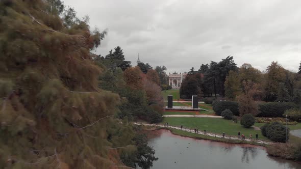 Drone passing trees in Sempione Park, Parco Sempione, Milan