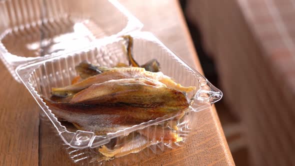 Salted Dried Fish in a Plastic Container Close Up