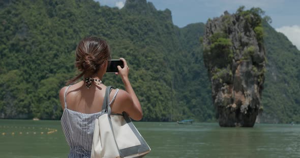 Woman take photo on Khao Phing Kan in thailand, phuket