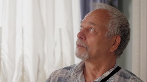 Retired Man Enjoys Excursion and Observes Museum Room