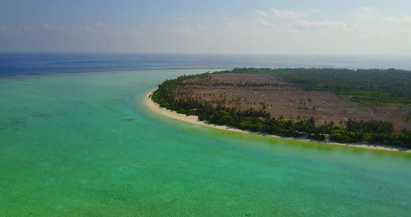 Beautiful aerial tourism shot of a paradise sunny white sand beach and aqua turquoise water backgrou