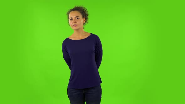 Curly Woman Standing in Front of the Camera, Saying Oh My God and Being Shocked. Green Screen