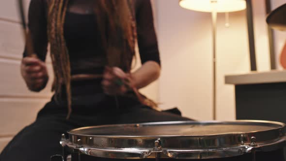 Female Drummer Playing In Studio