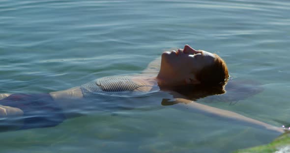 Woman Swimming in The Water at Beach 