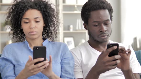 African Couple Using Smartphone