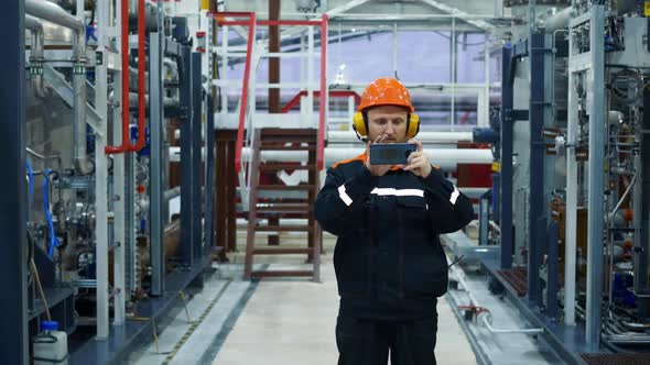 An Oil and Gas Industry Worker Stands in a Gas Compression Shop