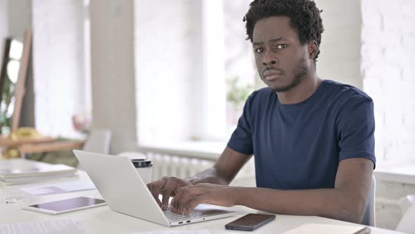 Portrait of Young African Man Saying No with Finger Sign