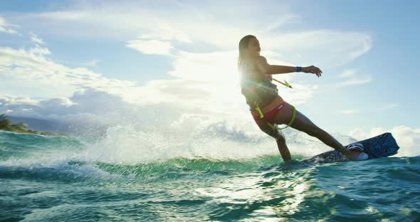 Woman Kiteboarding at Sunset