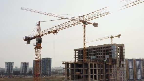 Aerial View Construction with High Tower Cranes Working on Building Site in Big City