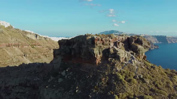 4k Aerial drone footage flying over Skaros rock to reveal dramatic scenery Caldera Santorini Greece