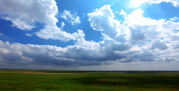 Green Field And Cloudy Sky