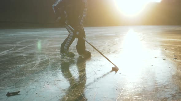 MOSCOW RUSSIA 10 DECEMBER 2019 Hockey Player on Frozen Lake Make Ice Sparkles on High Speed Braking