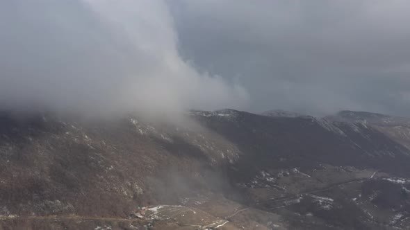 Aerial of clouds over the mountain top 4K drone footage