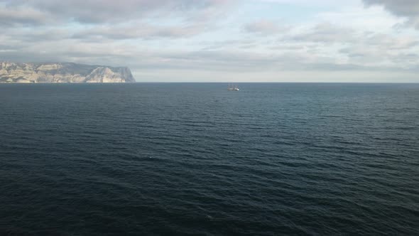 Aerial View From Above on Calm Azure Sea and Volcanic Rocky Shores