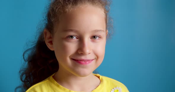 Portrait Funny Little Girl Smiling Child Looking at Camera are Sitting on the Blue Background Cute